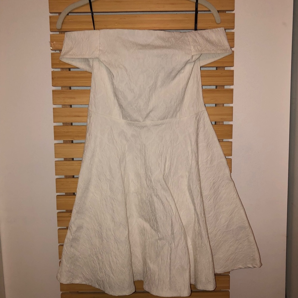 Off the shoulder white dress.